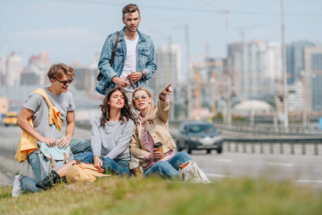 group of young travelers with backpacks in new city